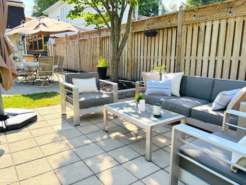 The lounge set on the new pavers, fence and tree behind
