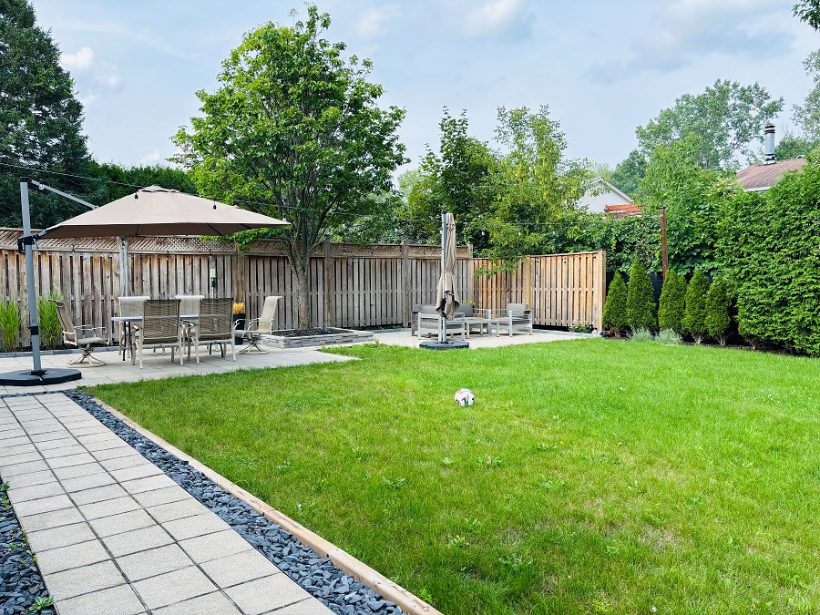 The lawn from the path, dining set at the far end